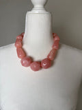 Blush Glow Statement Necklace featuring oversized glossy blush pink marbled beads in a chunky round beaded design.