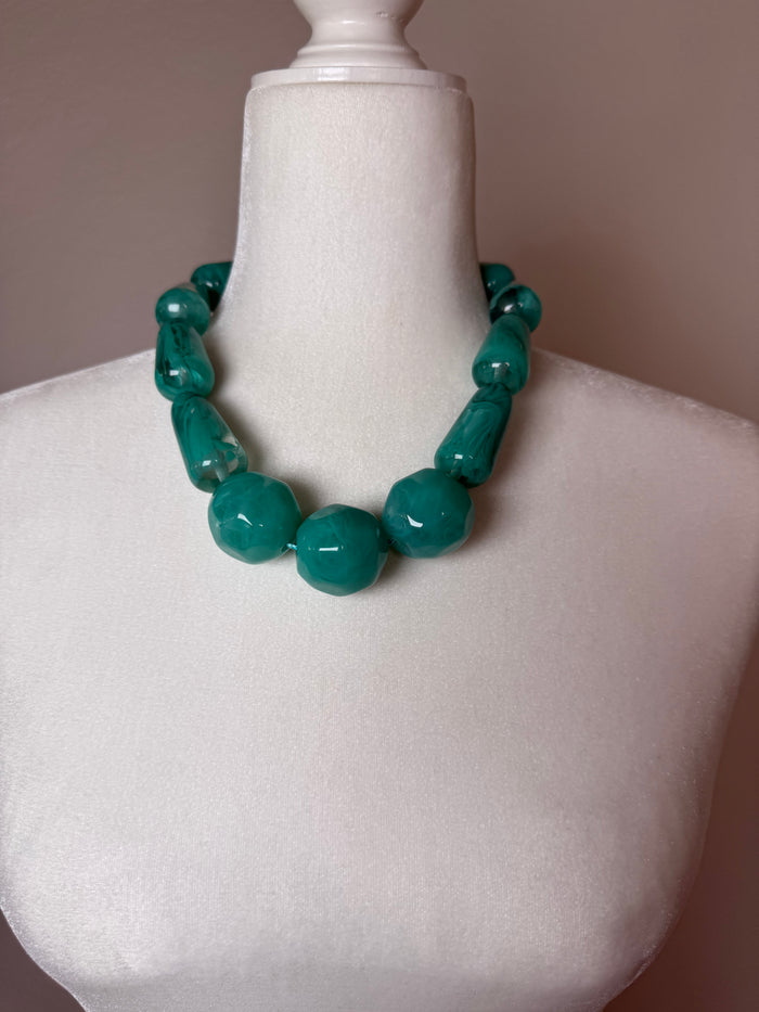 Teal Glow Statement Necklace with oversized glossy marbled teal beads in a chunky strand design.