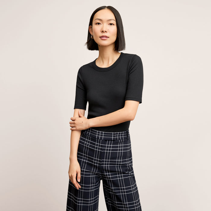 front image of a woman wearing the abby pant in plaid