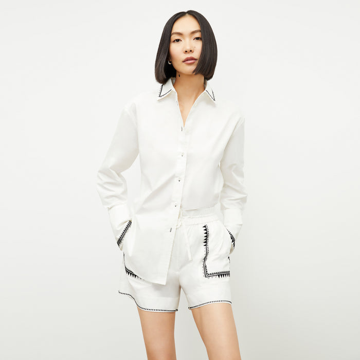 front image of a woman wearing the adina short in white | Lead