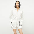 front image of a woman wearing the adina short in white | Lead