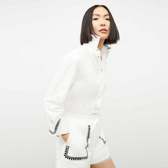 front image of a woman wearing the adina short in white