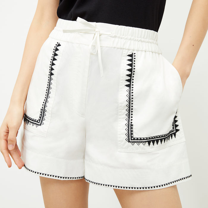 front image of a woman wearing the adina short in white