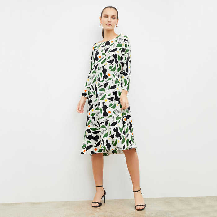 Front image of woman wearing the alesia dress in icon print
