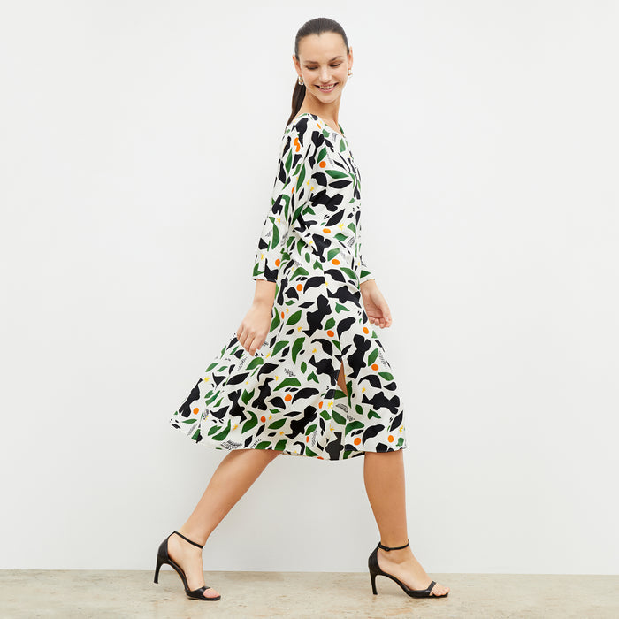 Side image of a woman wearing the alesia dress in icon print