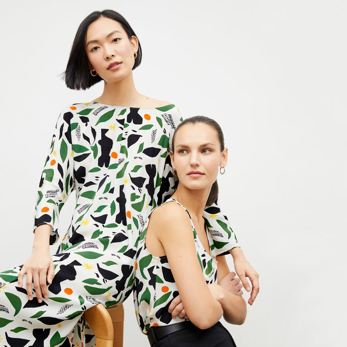 front image of woman wearing the alesia dress in icon print and woman wearing the vicky tank in icon print