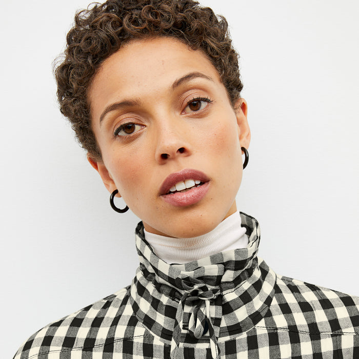 Detail image of a woman wearing the Allison Anorak - Luxe Gingham in black / white