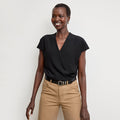 Front image of a woman standing wearing the antonia top soft wave in black | Lead