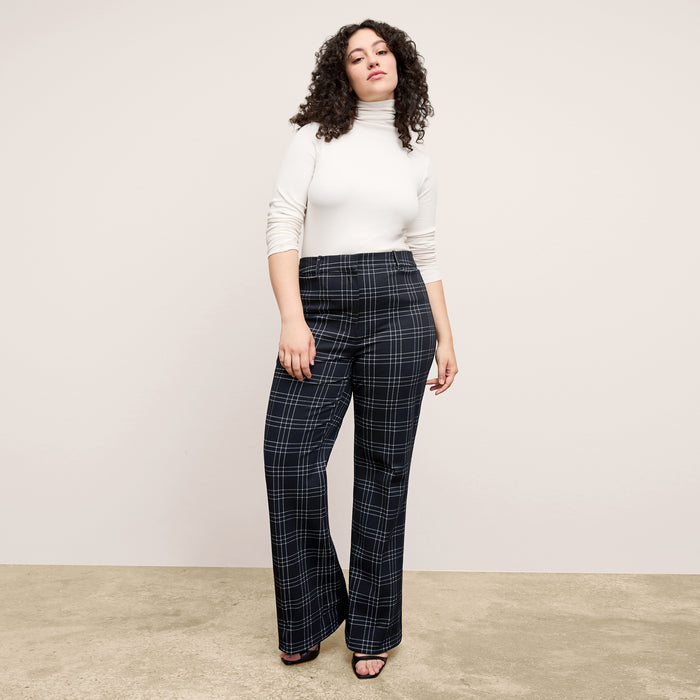 Front image of a woman standing wearing the axam top in ivory | Exclude