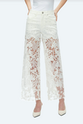White high rise wide leg jeans with floral lace cutout panels, rhinestone accents, five-pocket styling, and a raw hem.