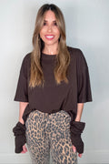 Neutral brown crewneck top with layered short sleeves, a relaxed hip-length shape, and subtle unfinished hem detail.
