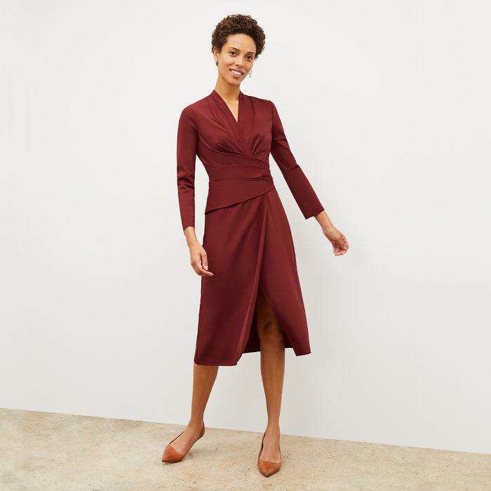 Front image of a woman wearing the carly dress in maroon