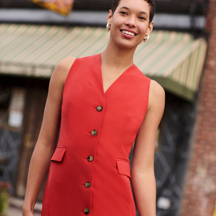Front image of a woman wearing the Cassandra Dress in Blood Orange