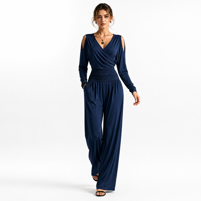 Navy Blue Milk Silk jumpsuit on a woman in a walking pose, highlighting the cold-shoulder sleeves, ruched waist and flowing wide legs.