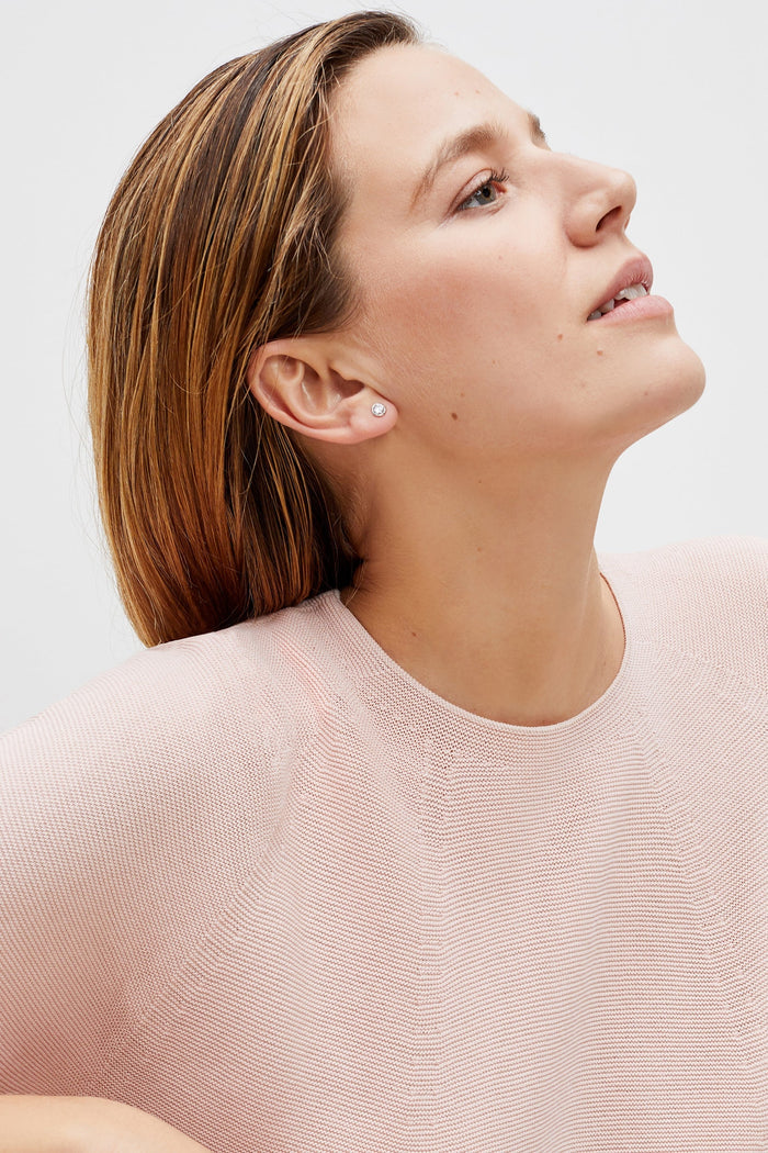 Detail image of a woman standing wearing the chadwick top in peony | Grid Hover | Exclude