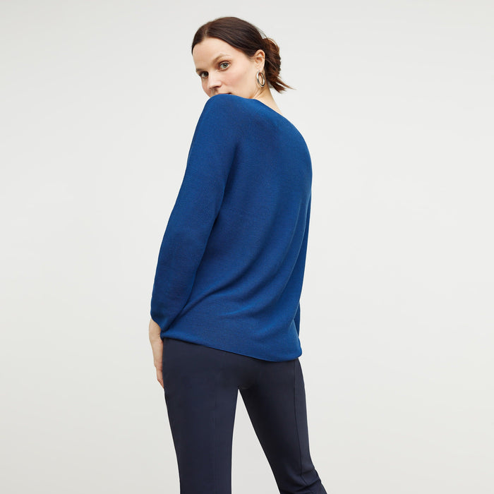 Back image of a woman standing wearing the chadwick top in shoreline