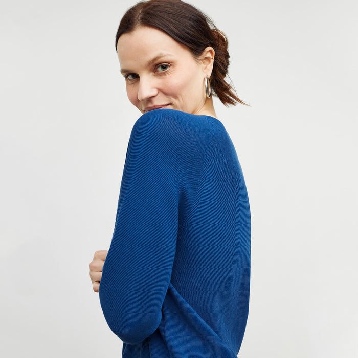 Side image of a woman standing wearing the chadwick top in shoreline
