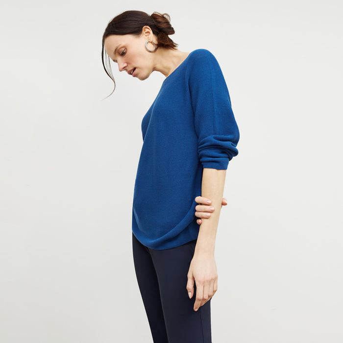 Side image of a woman standing wearing the chadwick top in shoreline