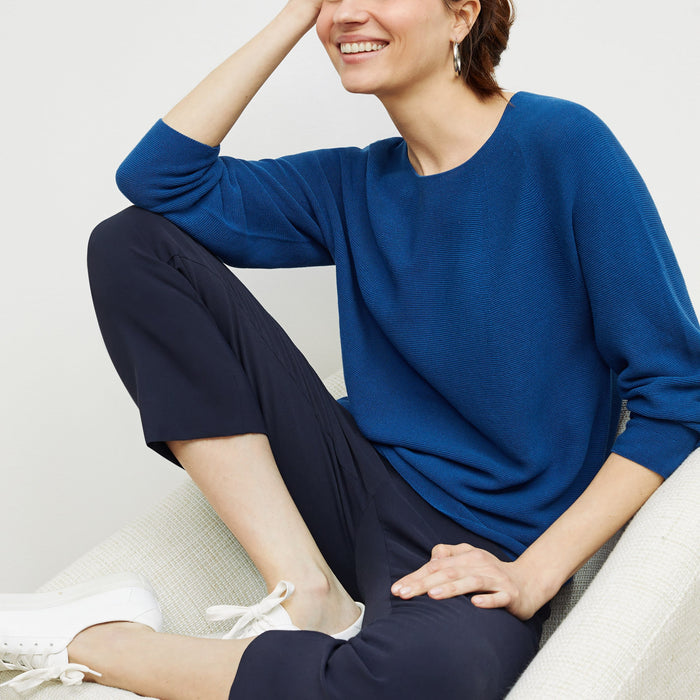 Side image of a woman standing wearing the chadwick top in shoreline