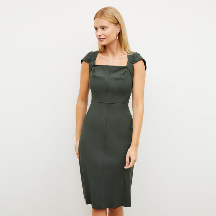 Image of a woman wearing the Charlene Dress in Dark Aloe