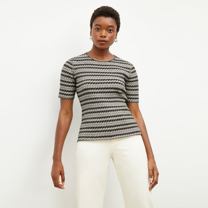 Front image of a woman wearing the charli in black and white