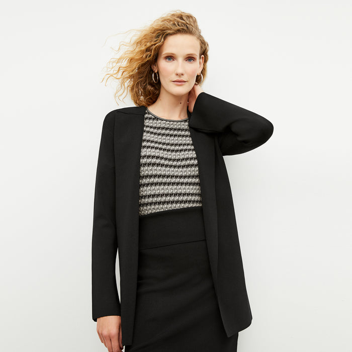 Front image of a woman wearing the charli in black and white