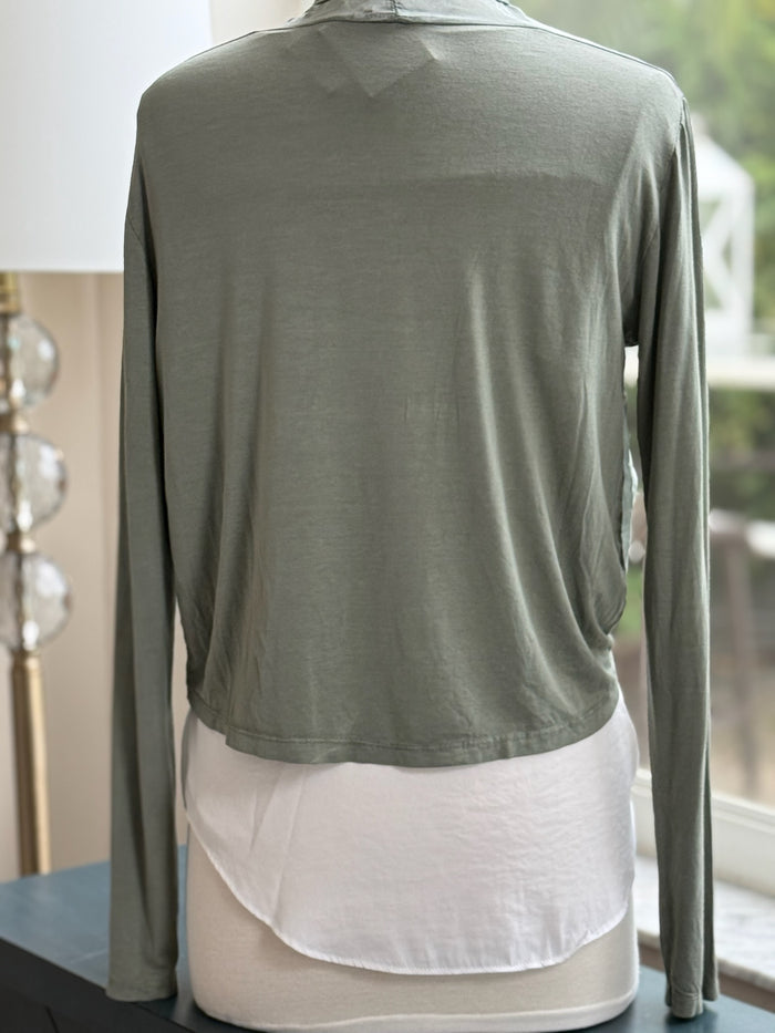 A green olive silk cardigan with a tie-front, displayed on a mannequin with  a necklace.