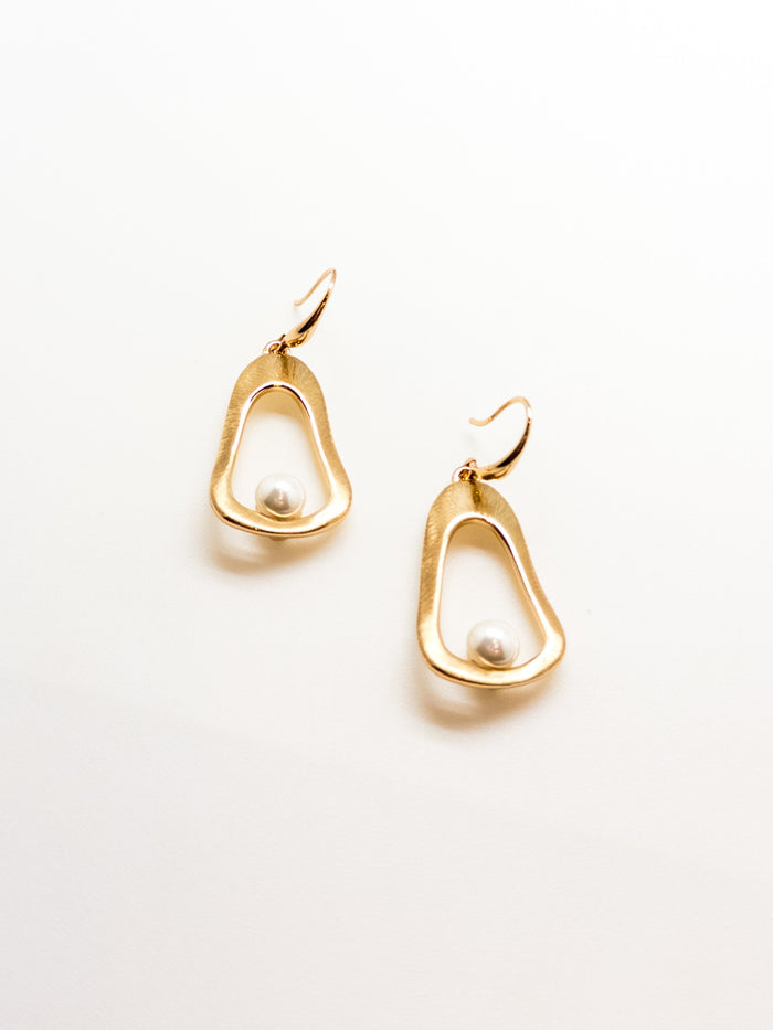 A pair of gold-tone hoop earrings with pearl accents on a white background.