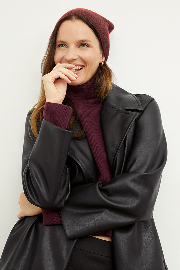 Front image of a woman wearing the Circle Cable Beanie in Chianti | Exclude