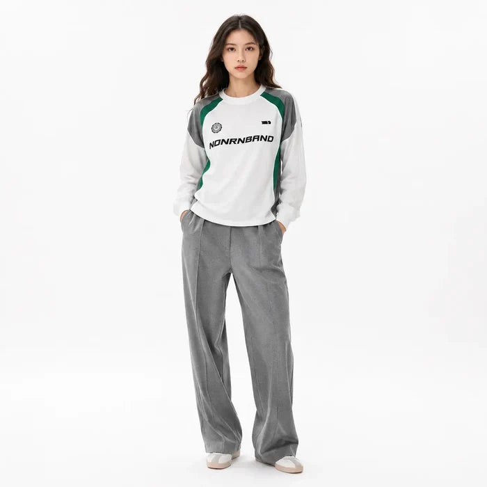 Professional female model wearing White color block raglan sleeve sweatshirt on white background, full face visible, square image.