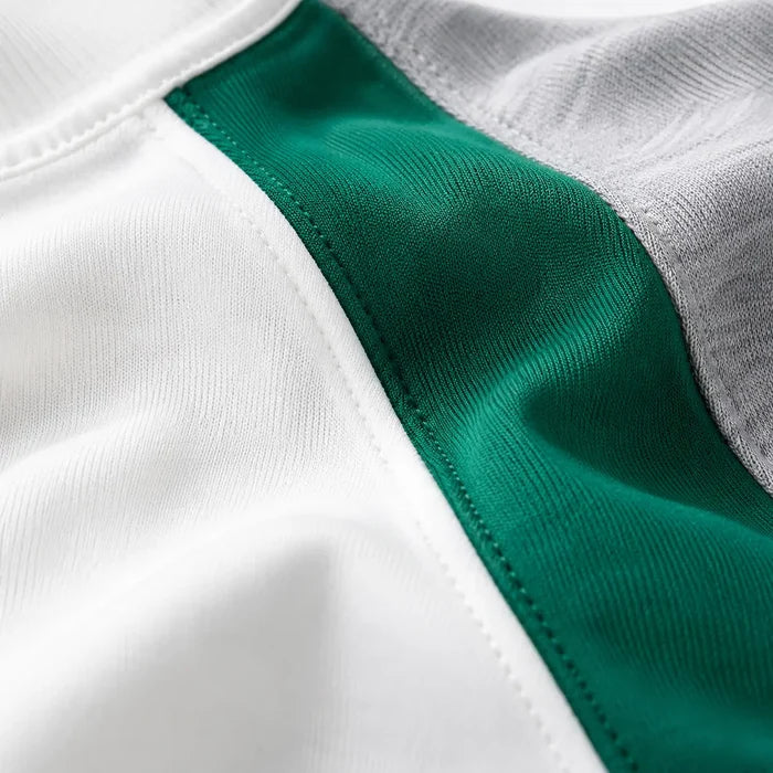 Macro view of White, green and gray sweatshirt fabric with clean stitching and slight-stretch material texture.