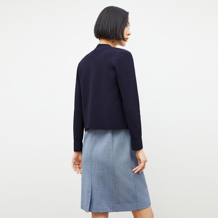 Back image of a woman wearing the constance dress in indigo and white