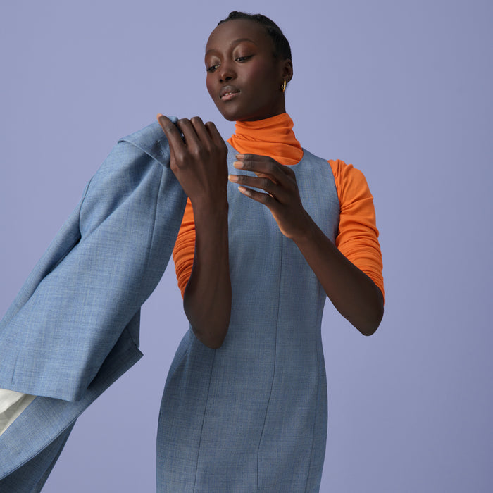 Front image of a woman wearing the constance dress in indigo and white