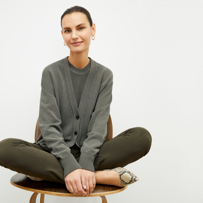 front image of a woman wearing the cookie cardigan in fossil | Lead