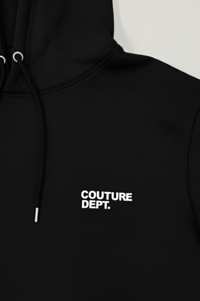 Close-up of the Couture Dept Fleece Tracksuit - Black, featuring a black hoodie with white drawstrings and "COUTURE DEPT." printed in white on the left chest, perfect for men's loungewear style.