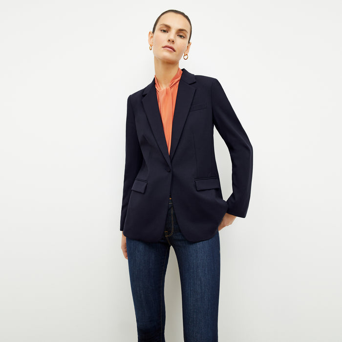 Front image of a woman wearing the Darcy Top in Guava