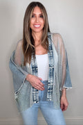 Medium wash denim open jacket with shimmering crystal mesh detail and western-inspired boutique styling.