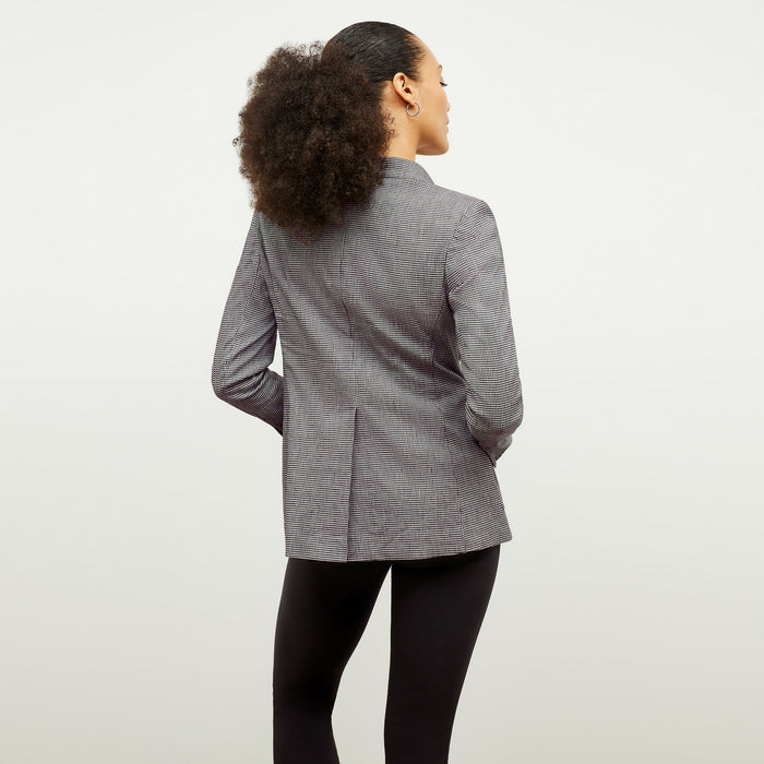 back image of a woman wearing the dolly jacket in gingham linen