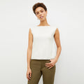 Front image of a woman standing wearing the Eileen Top in ivory | Lead