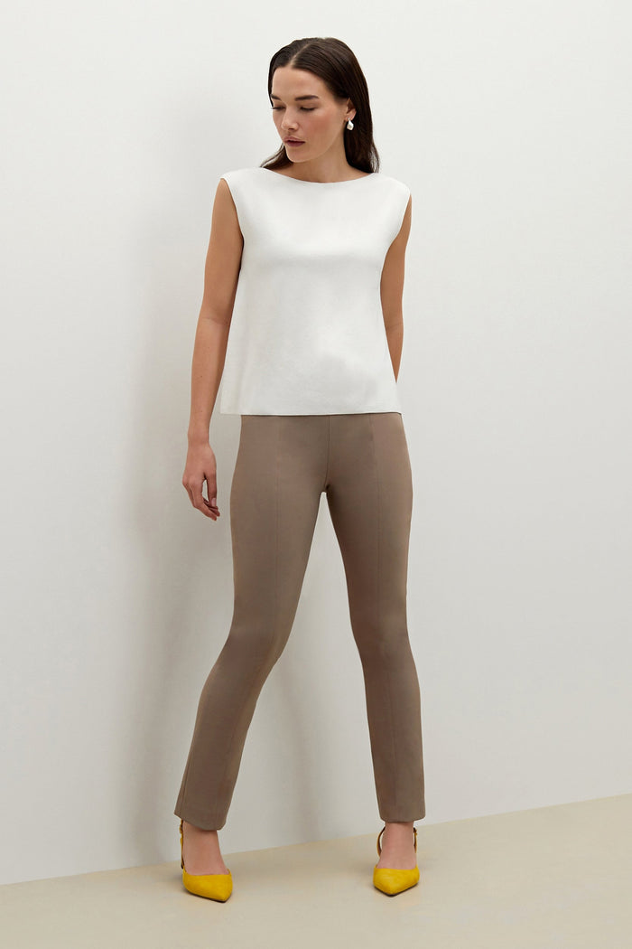 Side image of a woman standing wearing the Eileen top in ivory | Exclude