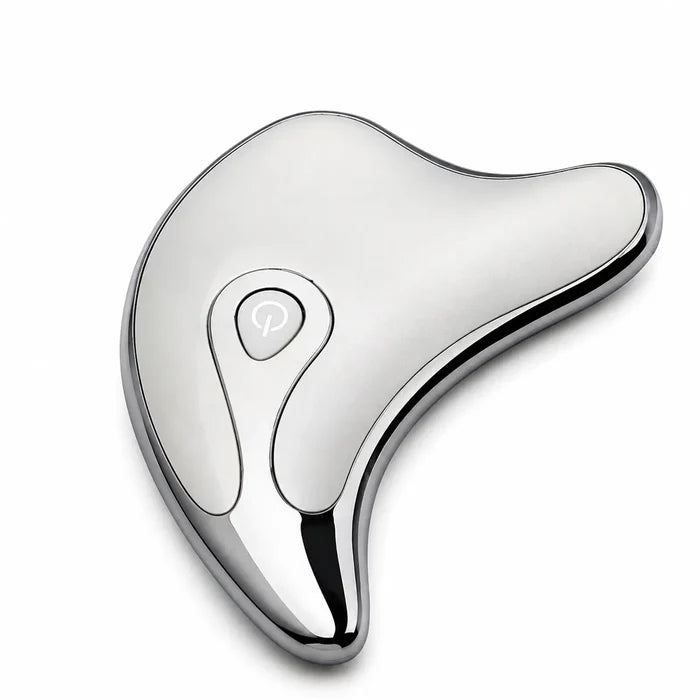 Silver face and body massage tool in a close top product view, showing its smooth finish, dark rim and teardrop control area.