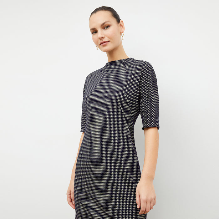 Front image of a woman wearing the farnoosh dress in black and white houndstooth | Lead