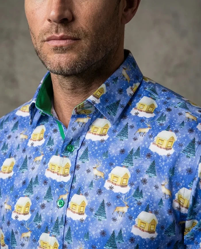 Man wearing a blue patterned shirt with winter-themed designs on a gray background