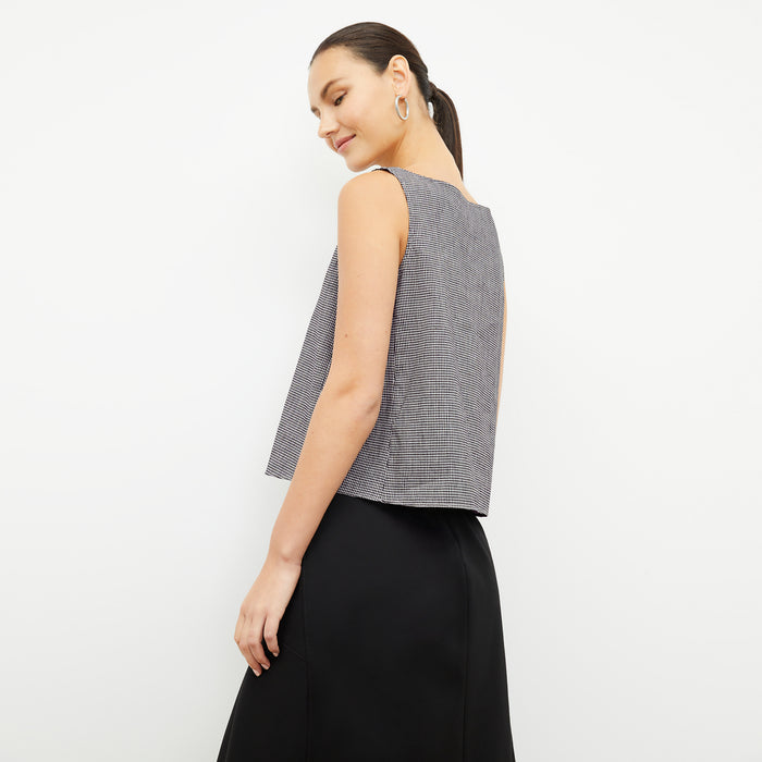 back image of a woman wearing the flaka top in gingham linen
