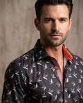 Man wearing a patterned shirt with a neutral background