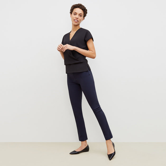 Front image of a woman standing wearing the foster pant in dark navy | Lead