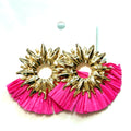 Fuchsia and gold ruffle statement earrings with an oversized open-center drop design and bold textured trim.