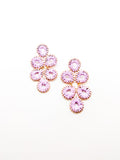A pair of purple floral-inspired earrings with a cascading design, made of gold-tone metal.