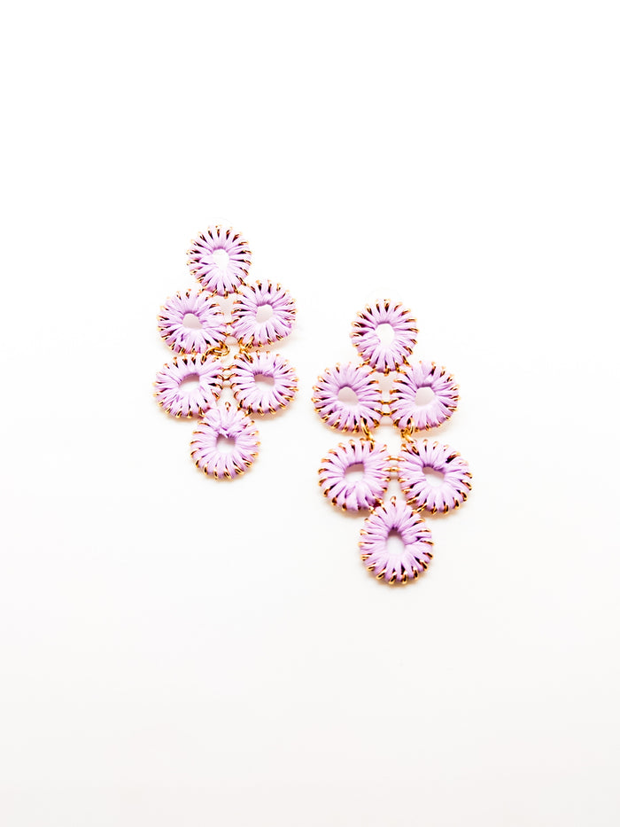 A pair of purple floral-inspired earrings with a cascading design, made of gold-tone metal.