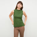 front image of a woman wearing the giulia top in basil | Lead